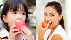 A fresh red apple on a wooden table symbolizes its health benefits, such as improved digestion, heart health, and immune support.